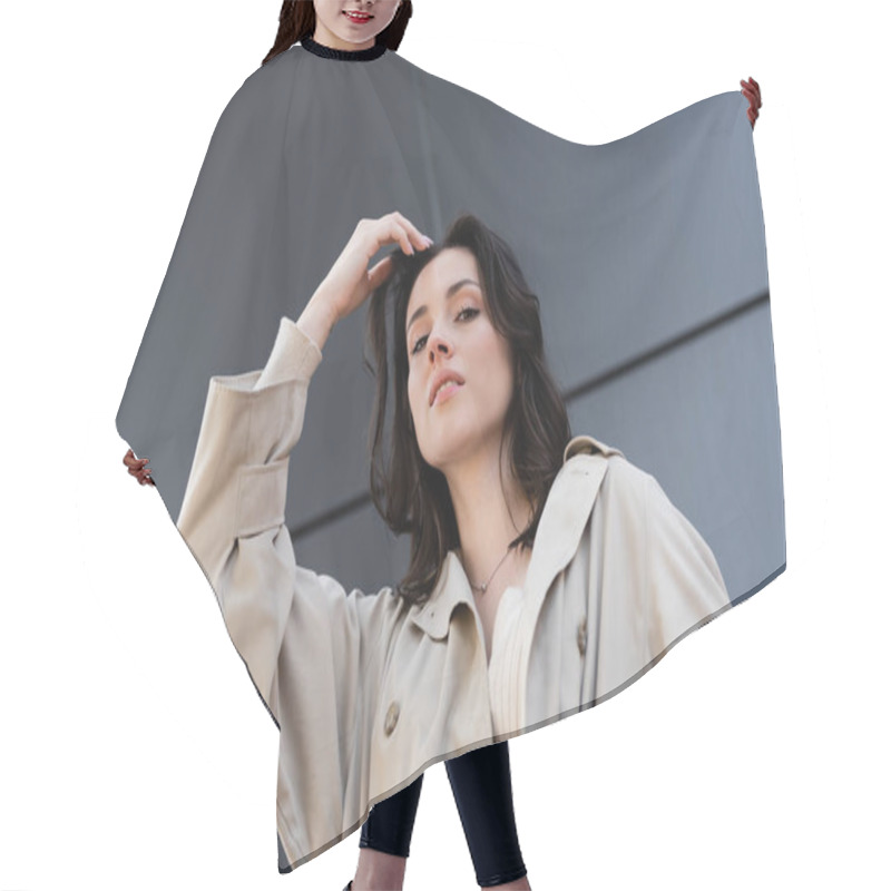 Personality  Low Angle View Of Brunette Woman In Beige Coat Posing With Hand Near Head Outdoors Hair Cutting Cape