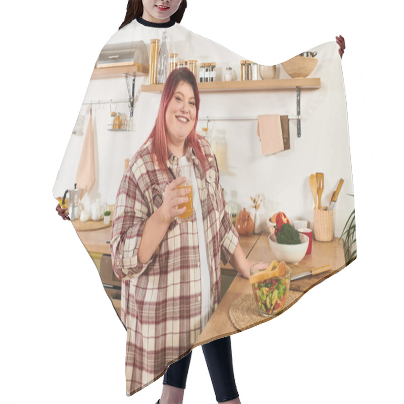 Personality  A Young Woman Smiles While Holding A Drink, Preparing A Fresh Salad In Her Stylish Kitchen Hair Cutting Cape