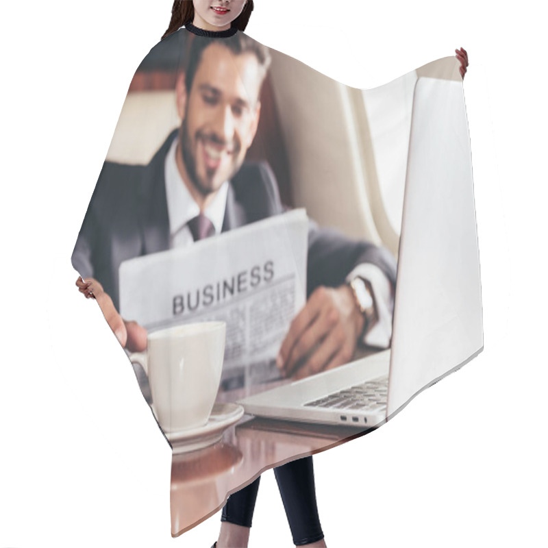 Personality  Selective Focus Of Smiling Businessman In Suit With Newspaper Taking Cup In Private Plane  Hair Cutting Cape