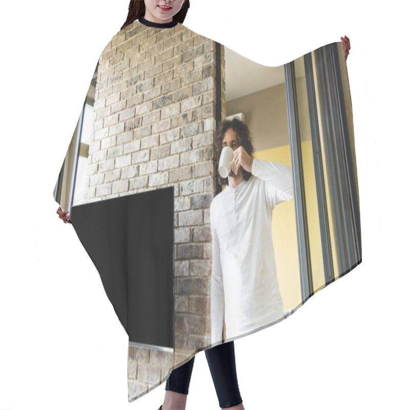 Personality  Young Man In Pajamas Drinking Coffee While Standing Near Blank Lcd Screen Hanging On Brick Wall Hair Cutting Cape