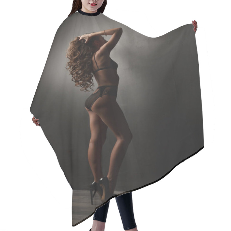 Personality  Sensual And Appealing Young Woman With Dark Wavy Hair, Long Legs And Bronzed Skin Is Posing In The Black Lacy Translucent Underwear In The Studio Room Near The Wall, Back View Hair Cutting Cape