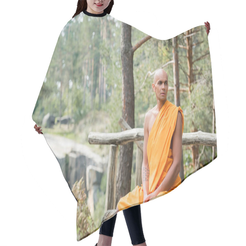 Personality  Buddhist Monk In Traditional Orange Robe Sitting On Log Bench In Forest Hair Cutting Cape