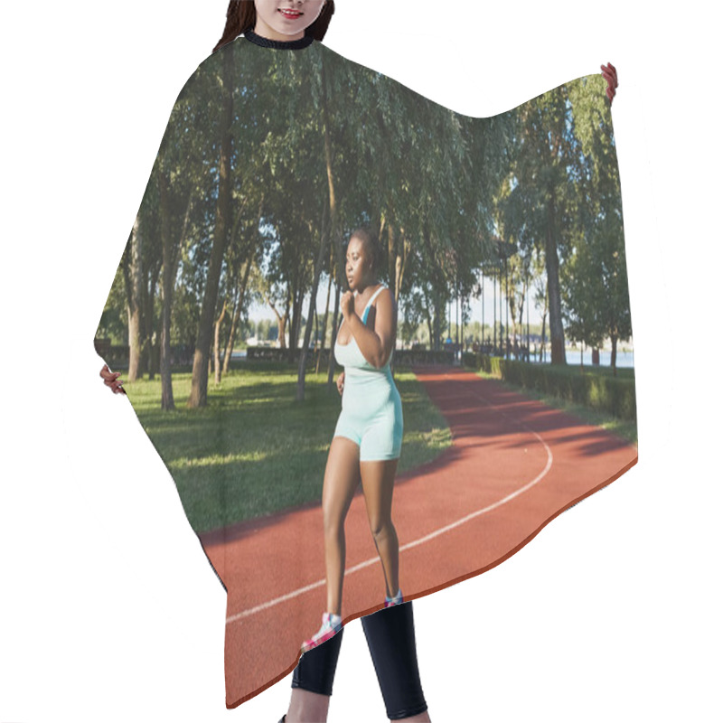 Personality  An African American Woman In Sportswear Energetically Runs Along A Track, Exuding Confidence And Power. Hair Cutting Cape