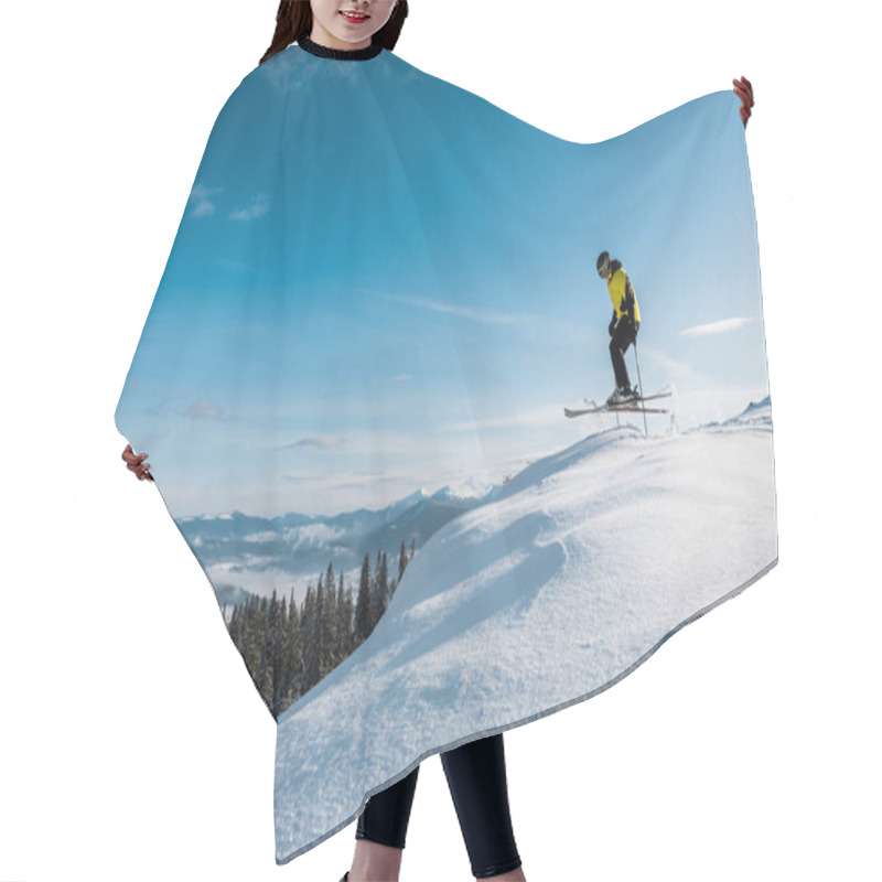 Personality  Side View Of Skier Holding Ski Sticks And Jumping Against Blue Sky In Mountains  Hair Cutting Cape