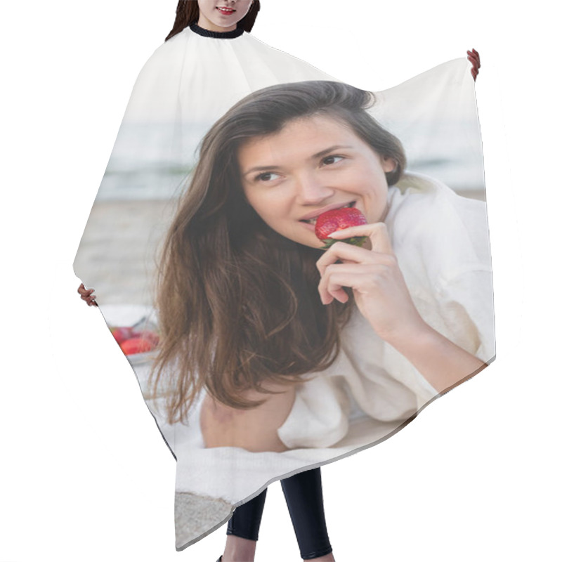 Personality  Smiling Brunette Woman Eating Strawberry On Blanket On Beach  Hair Cutting Cape