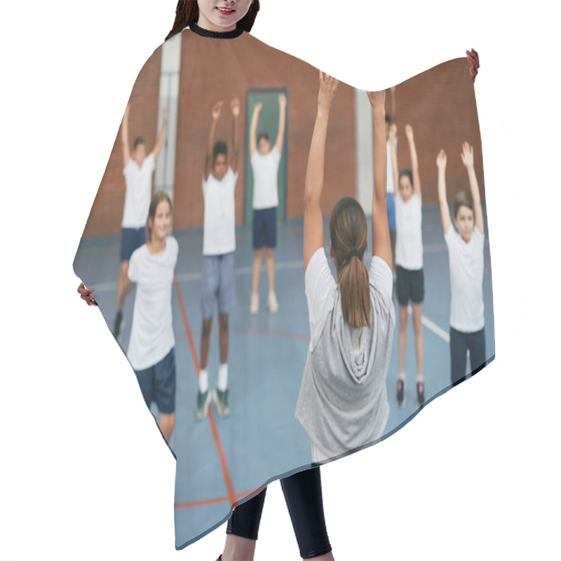 Personality  Back View Of PE Teacher And Group Of Elementary Students Exercising During A Class At School Gym.  Hair Cutting Cape