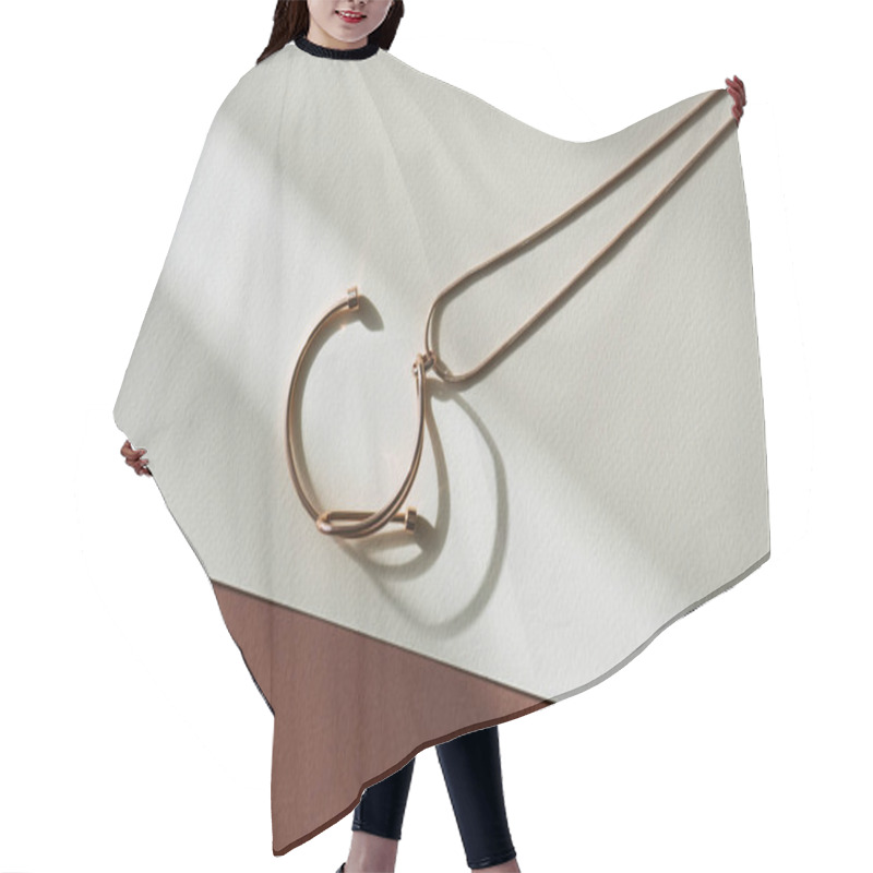 Personality  Top View Of Beautiful Round Necklace On White And Beige Surface With Sunlight Hair Cutting Cape