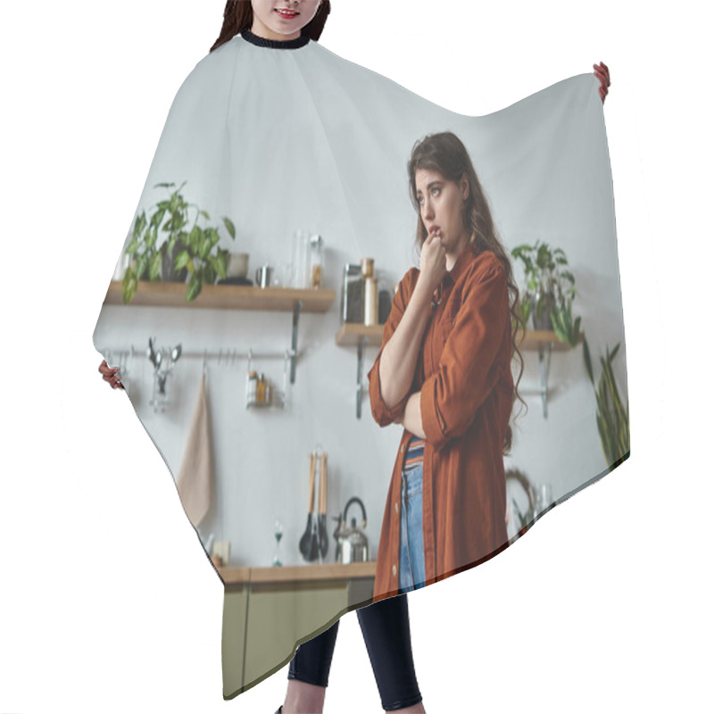 Personality  A Woman Stands Thoughtfully In A Serene Kitchen, Surrounded By Greenery, Reflecting On Her Feelings. Hair Cutting Cape