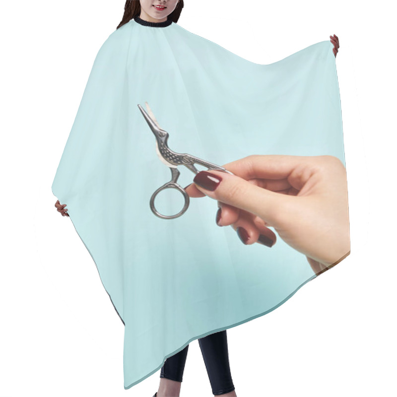 Personality  Bird Like Scissors In Hand Of Young Unknown Woman With Nail Polish On Vibrant Blue Backdrop Hair Cutting Cape