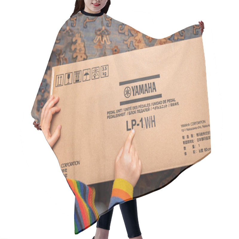 Personality  Paris, France - Nov 3, 2024: Child Pointing To The Yamaha LP-1WH Pedal Unit Box During Unboxing, Excitedly Examining The Product Branding On The Packaging Hair Cutting Cape