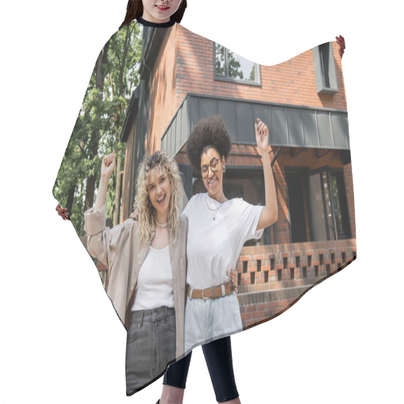 Personality  Excited Multicultural Lesbian Women Rejoicing And Showing Win Gesture Near Private Cottage Hair Cutting Cape