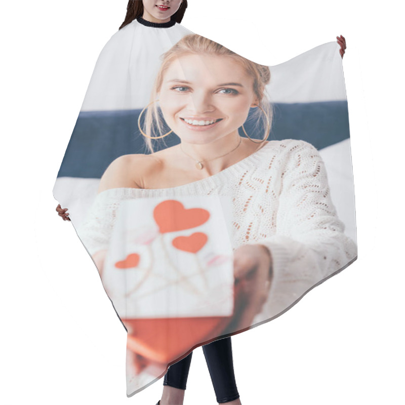 Personality  Selective Focus Of Happy Woman Holding Gift Box And Valentine Card On Bed  Hair Cutting Cape