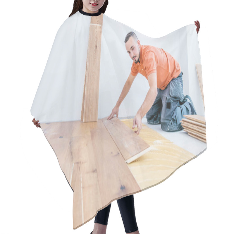 Personality  Worker Installing Parquet Floor On Construction Site. Lay Parquet Floor    Hair Cutting Cape