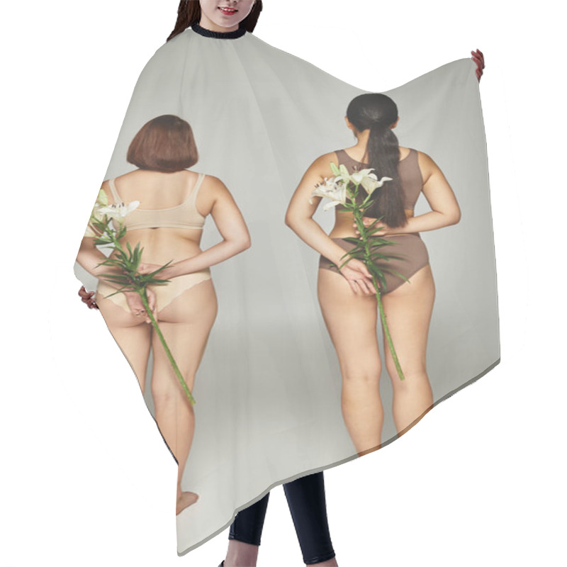 Personality  Back View Of Two Women In Beige Lingerie Standing With White Lilies In Hands On Grey Backdrop Hair Cutting Cape