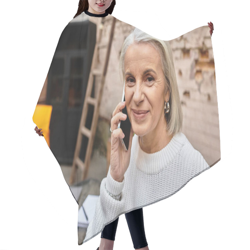 Personality  In A Cozy Outdoor Cafe, A Mature Woman Engages In A Delightful Phone Conversation While Smiling. Hair Cutting Cape