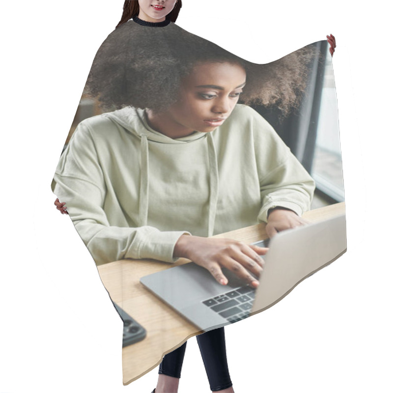 Personality  A Black Woman Sits At A Table, Intensely Focused On Her Laptop In A Modern Coworking Space Hair Cutting Cape