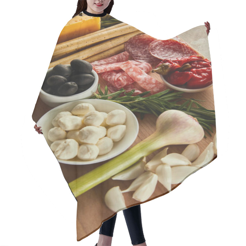 Personality  High Angle View Of Board With Antipasto Ingredients And Bowls With Mozzarella, Olives And Marinated Chili Peppers On Brown Hair Cutting Cape