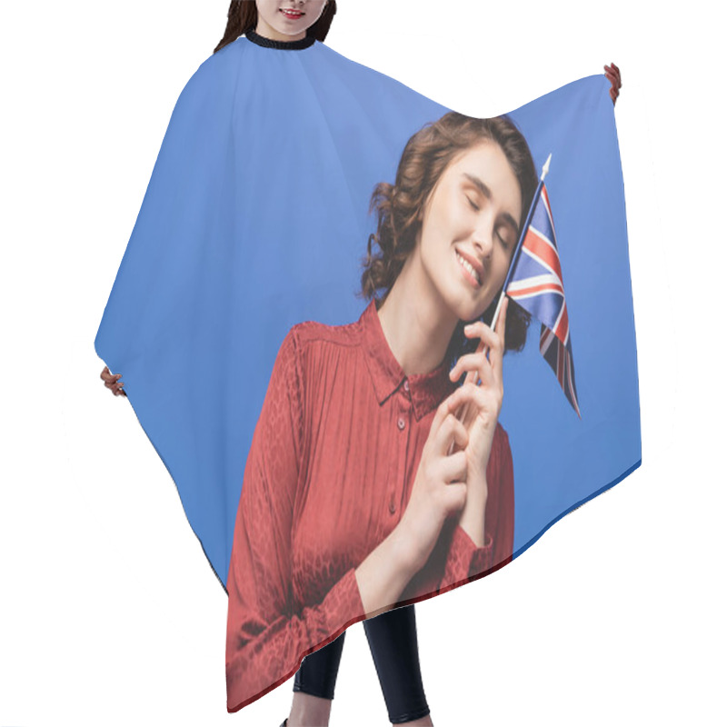 Personality  Pleased Language Teacher Smiling While Holding Flag Of United Kingdom Isolated On Blue  Hair Cutting Cape