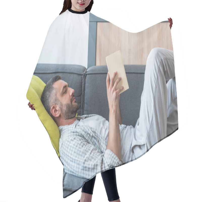 Personality  Side View Of Bearded Man Reading Book While Lying On Couch At Home Hair Cutting Cape