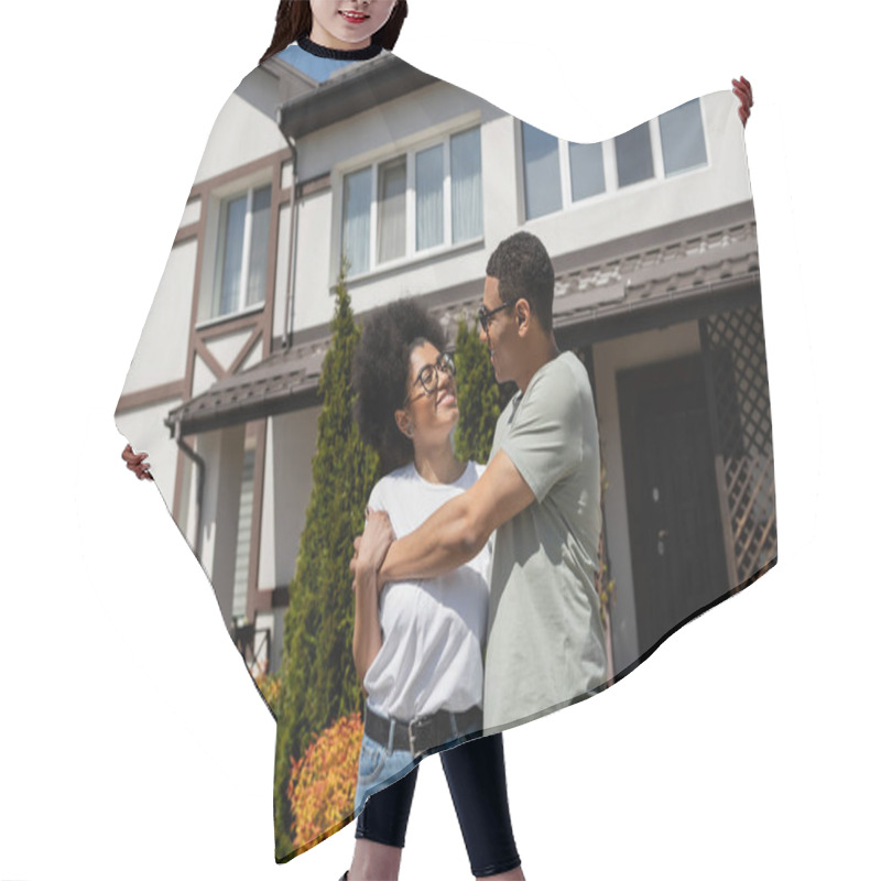 Personality  Cheerful African American Couple Hugging While Standing Near New House Outdoors Hair Cutting Cape