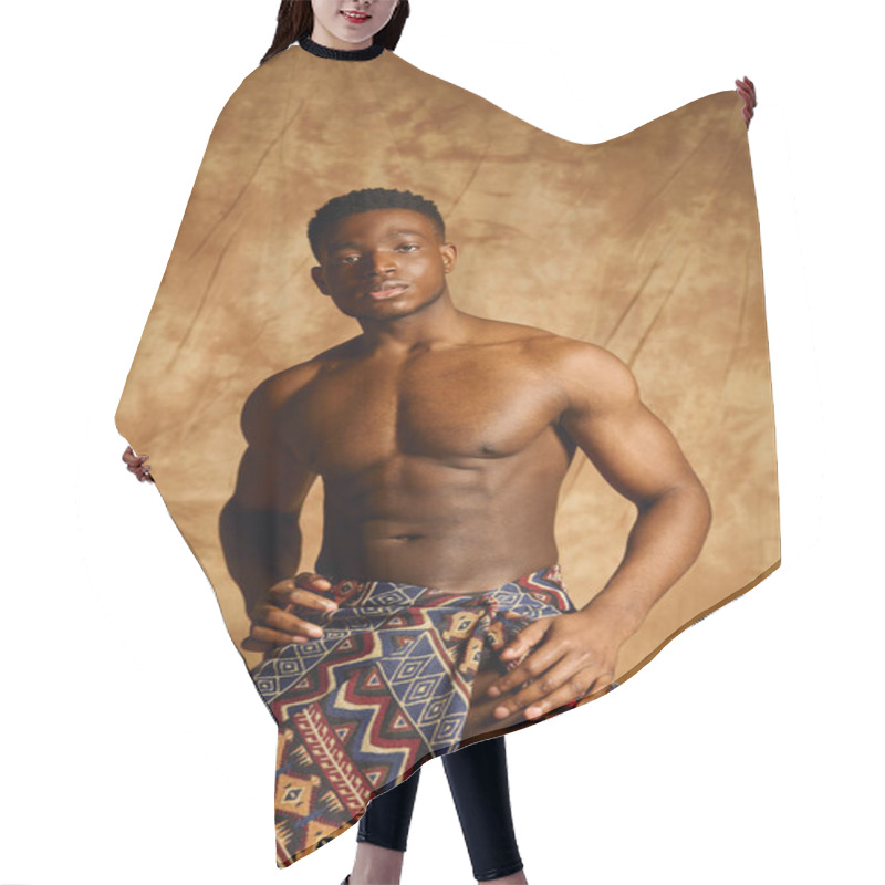 Personality  A Youthful And Attractive African American Man Presents A Powerful Stance Without A Shirt. He Wears A Colorful Wrap And Stands Against A Textured Brown Backdrop, Exuding Confidence And Charisma. Hair Cutting Cape