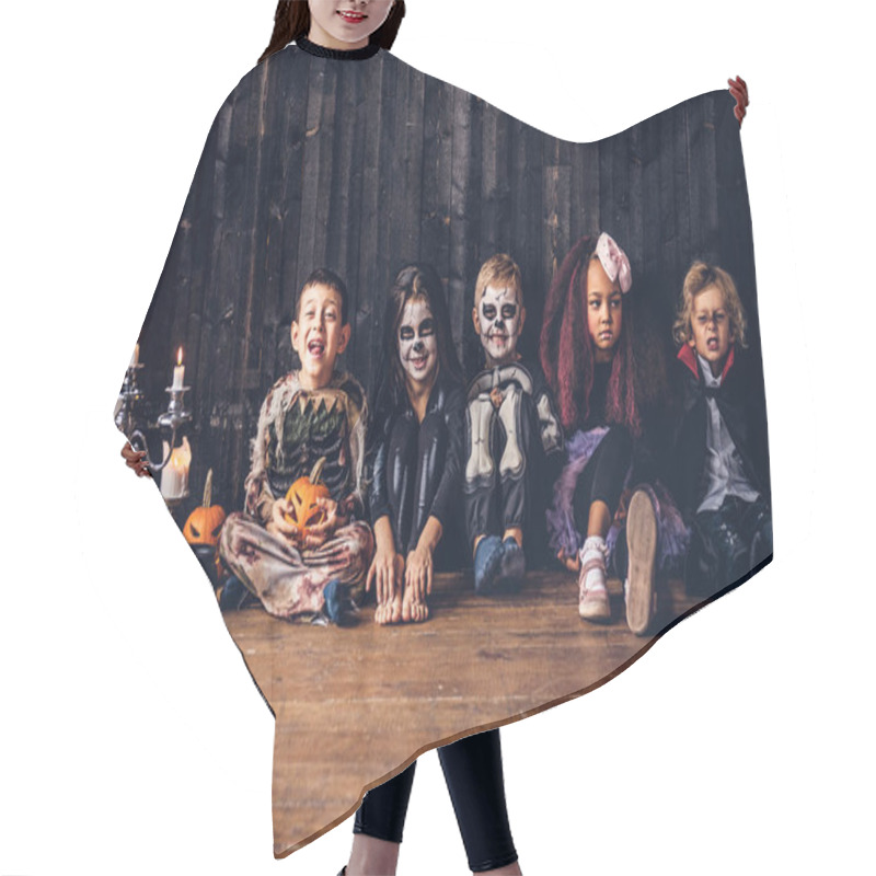 Personality  Halloween Party With Group Children Who Sitting Together On A Wooden Floor In An Old House. Halloween Concept. Hair Cutting Cape