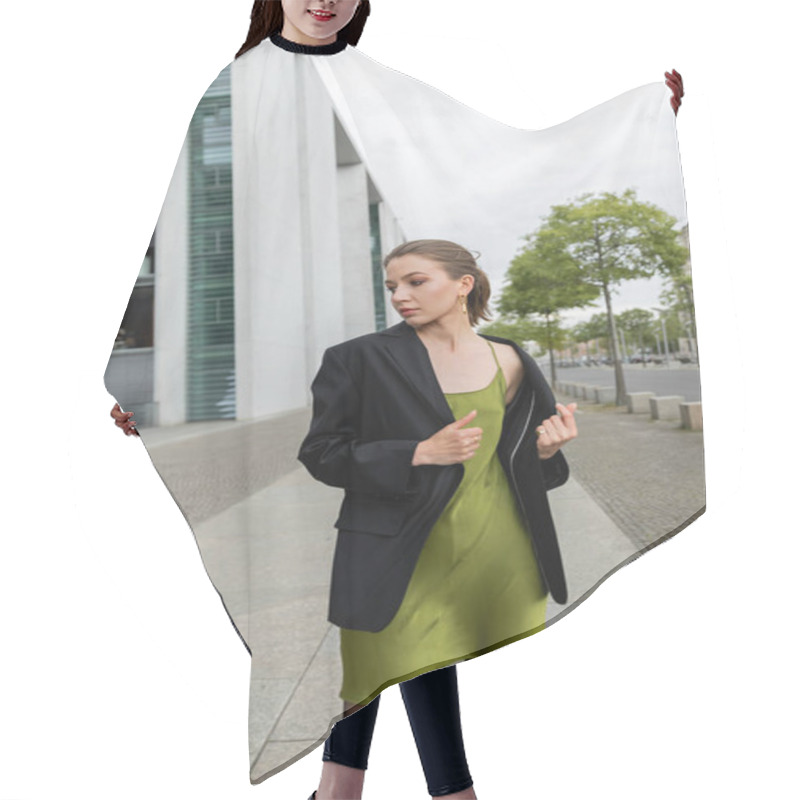 Personality  Stylish Young Woman In Black Blazer And Silk Dress Looking Away While Standing In Berlin, Germany  Hair Cutting Cape