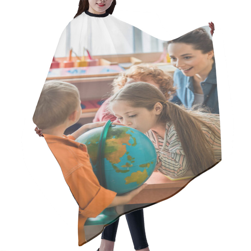 Personality  Curious Girl Looking At Globe Near Children And Blurred Teacher In Classroom Hair Cutting Cape