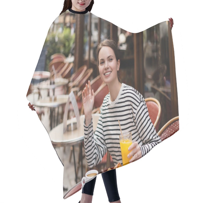 Personality  Smiling Woman In Striped Long Sleeve Shirt Holding Glass Of Orange Juice And Waving Hand In Outdoor Cafe In Paris Hair Cutting Cape