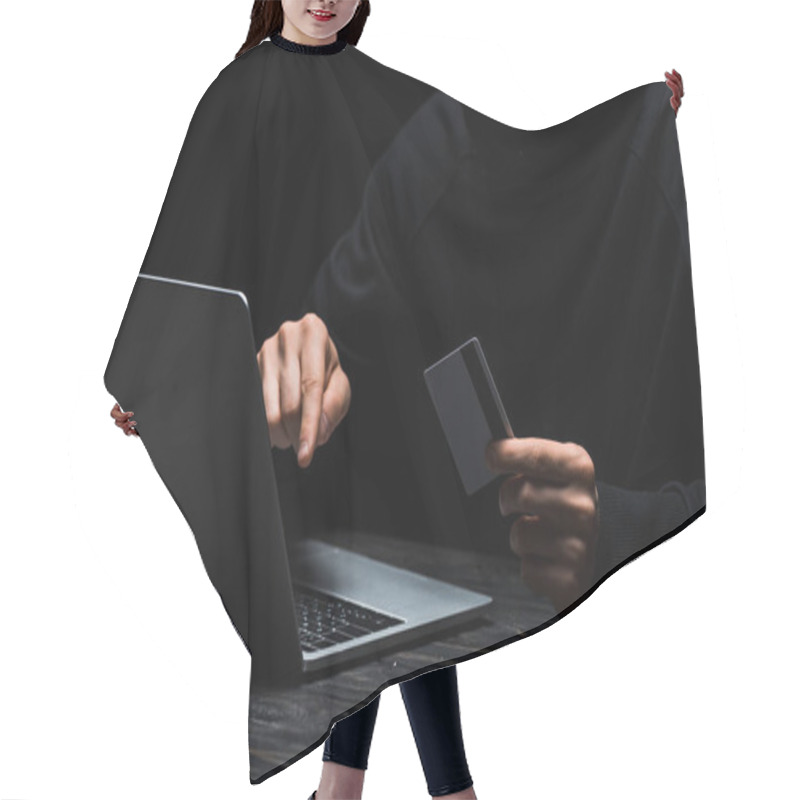 Personality  Cropped View Of Hacker Using Laptop While Holding Credit Card Isolated On Black  Hair Cutting Cape