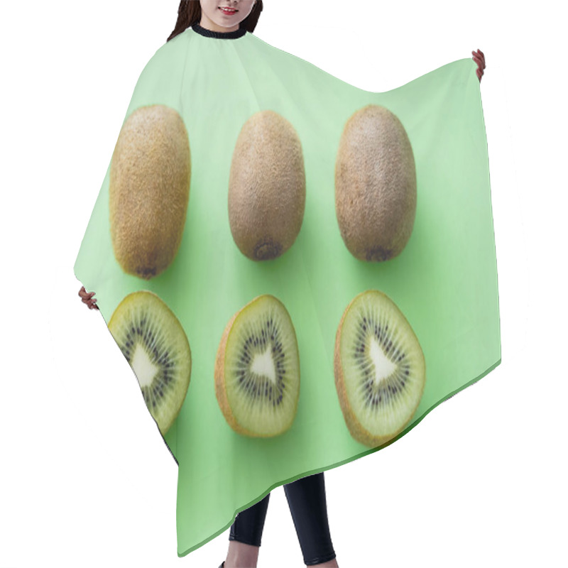 Personality  Flat Lay Of Organic Kiwi Fruit On Green Hair Cutting Cape