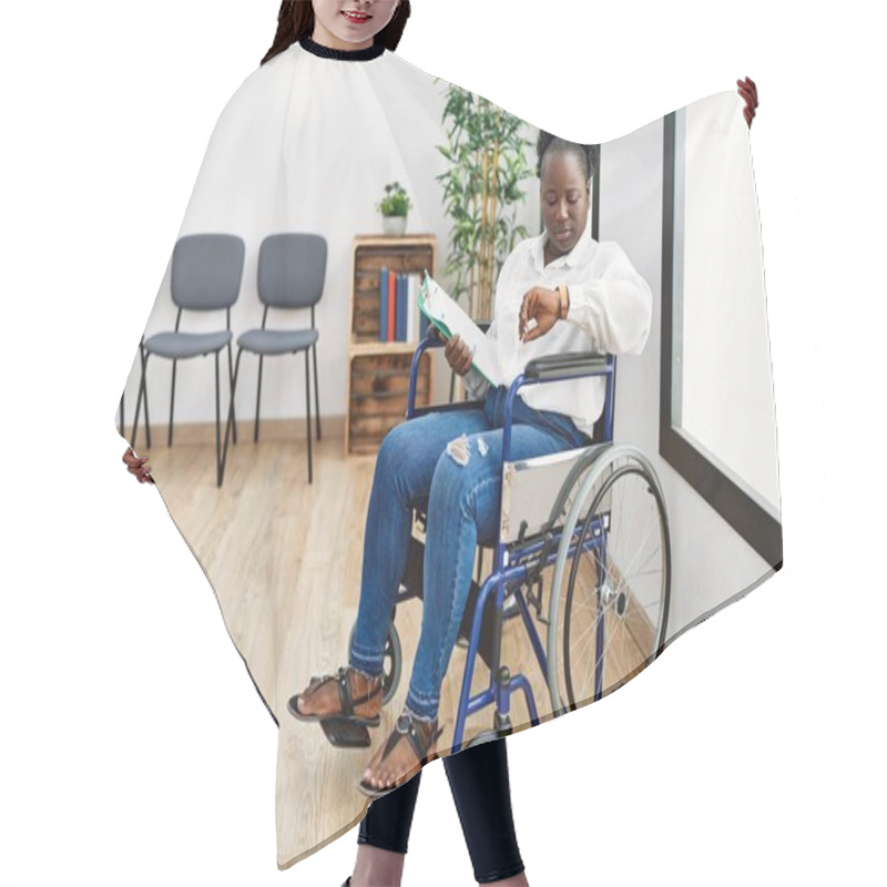 Personality  Young Black Woman Sitting On Wheelchair At Waiting Room Checking The Time On Wrist Watch, Relaxed And Confident  Hair Cutting Cape