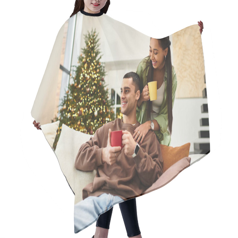 Personality  A Beautiful Couple Enjoys Holiday Drinks Together In Their Decorated Living Room. Hair Cutting Cape