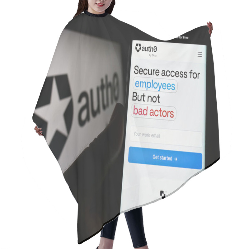 Personality  Stuttgart, Germany - 08-20-2023: Person Holding Cellphone With Webpage Of US Identity Platform Company Auth0 By Okta On Screen In Front Of Logo. Focus On Center Of Phone Display. Hair Cutting Cape