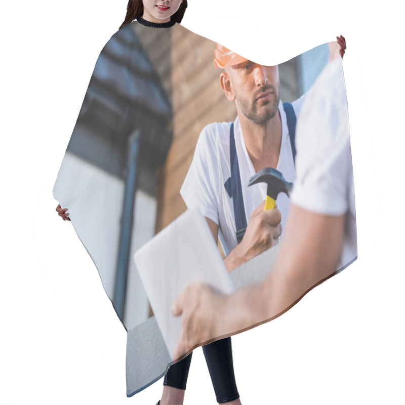 Personality  Selective Focus Of Builder With Hammer Looking At Colleague With Digital Tablet On Roof Of Building  Hair Cutting Cape