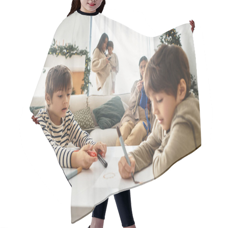 Personality  A Happy Asian Family Enjoys Quality Time Together Near A Beautifully Decorated Christmas Tree. Hair Cutting Cape