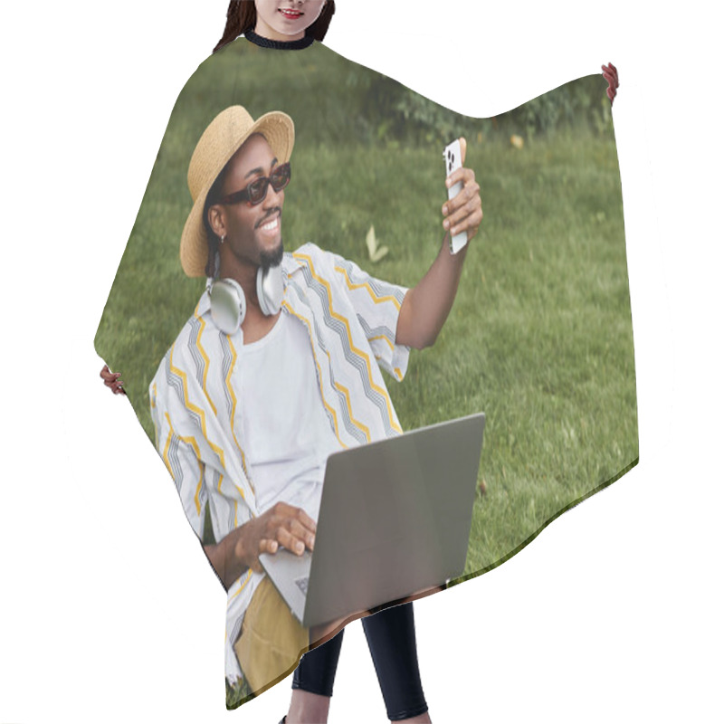 Personality  A Young African American Man Relaxes On Grass, Working On His Laptop And Taking Selfies. Hair Cutting Cape