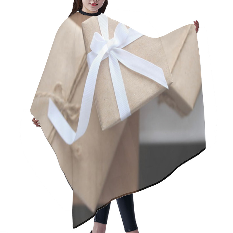 Personality  Gift Boxes For Holidays. Present Box Wrapped In Kraft Paper Decorated With White Ribbon Bow. Festive Gifts For Christmas And New Year, Valentine's Day, International Women's Day. Hair Cutting Cape