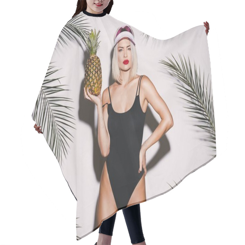 Personality  Pretty Girl With Blonde Hair Wearing Black Swimming Suit And Pink Cap Standing With Pineapple On White Studio Background Hair Cutting Cape