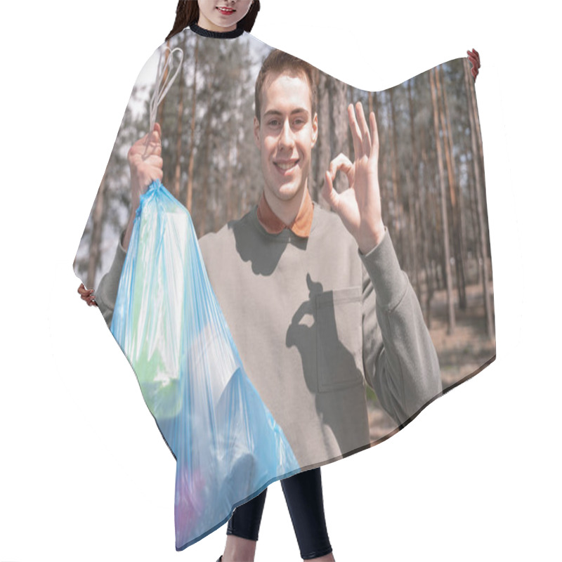 Personality  Happy Young Man Holding Blue Trash Bag And Showing Ok Sign In Forest  Hair Cutting Cape