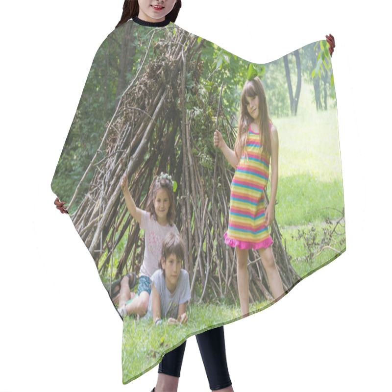 Personality  Kids Playing Next To Wooden Stick House Hair Cutting Cape