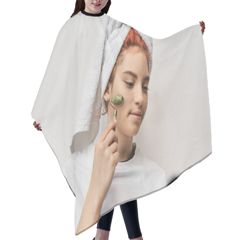 Personality  Attractive Red Haired Queer Person In Homewear Using Face Roller While Relaxing On Bed With Laptop Hair Cutting Cape