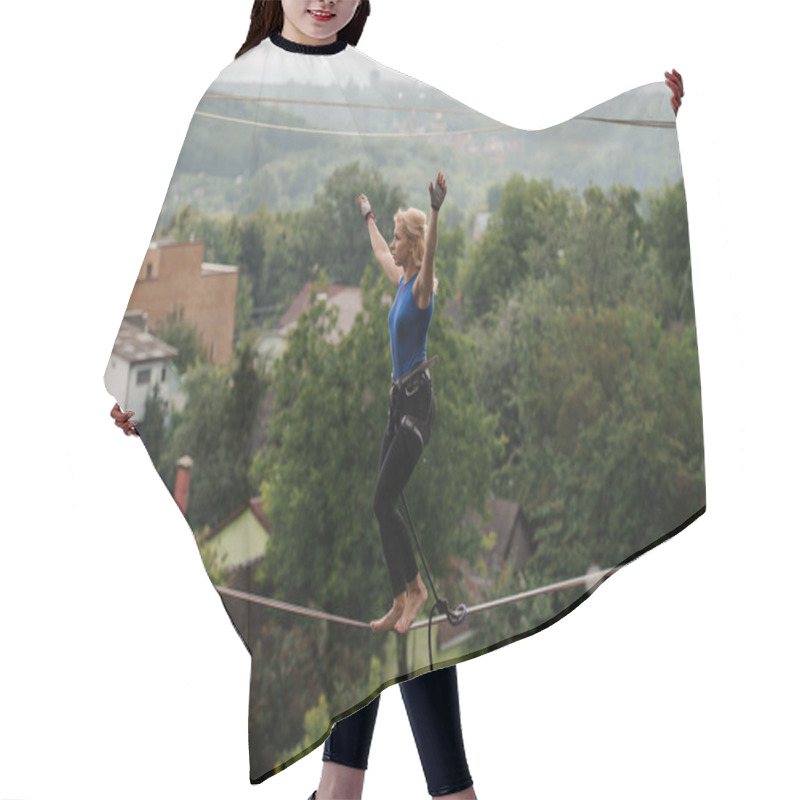 Personality  Young Woman Standing On The Slackline Rope On The Bending Knees On The Background Of Houses Among Trees And Clear Sky Hair Cutting Cape