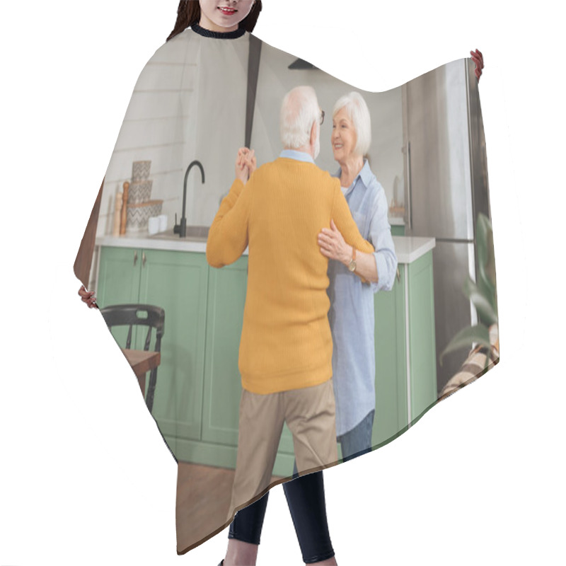 Personality  Back View Of Elderly Husband Dancing With Happy Wife In Kitchen Hair Cutting Cape