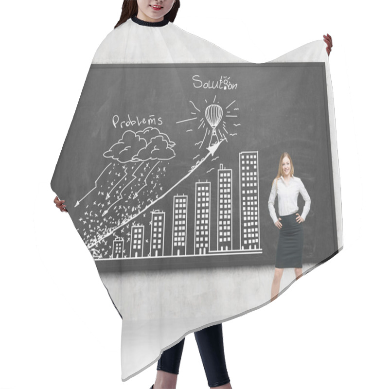 Personality  A Brunette Young Woman In Formal Clothes Holds Her Hands On The Waist. Young Professional Presents ' Problems And Solution ' Strategy With The Graph On The Black Chalkboard. Concrete Room. Hair Cutting Cape