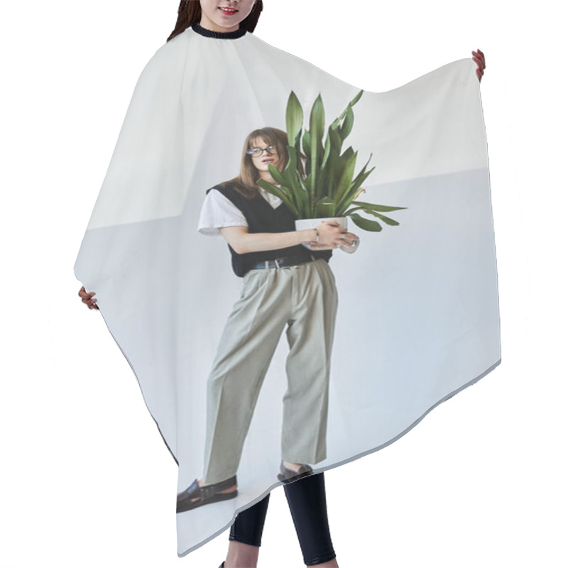 Personality  A Fashionable Young Man Poses Confidently With A Large Green Plant In An Elegant, Bright Space. Hair Cutting Cape