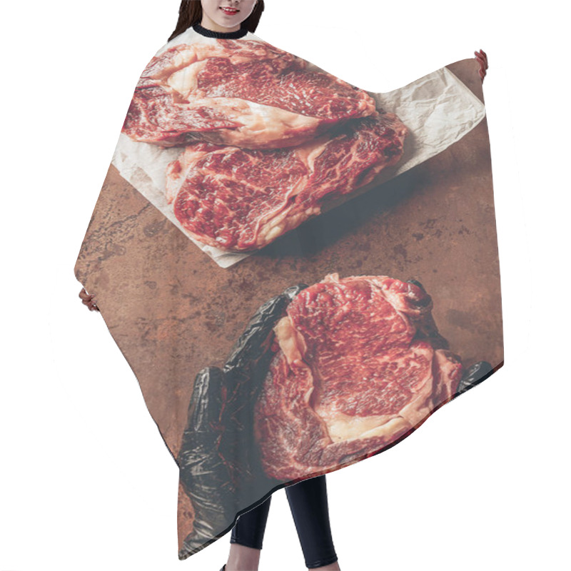 Personality  Cropped Image Of Butcher Holding Raw Meat For Steak In Hands Hair Cutting Cape