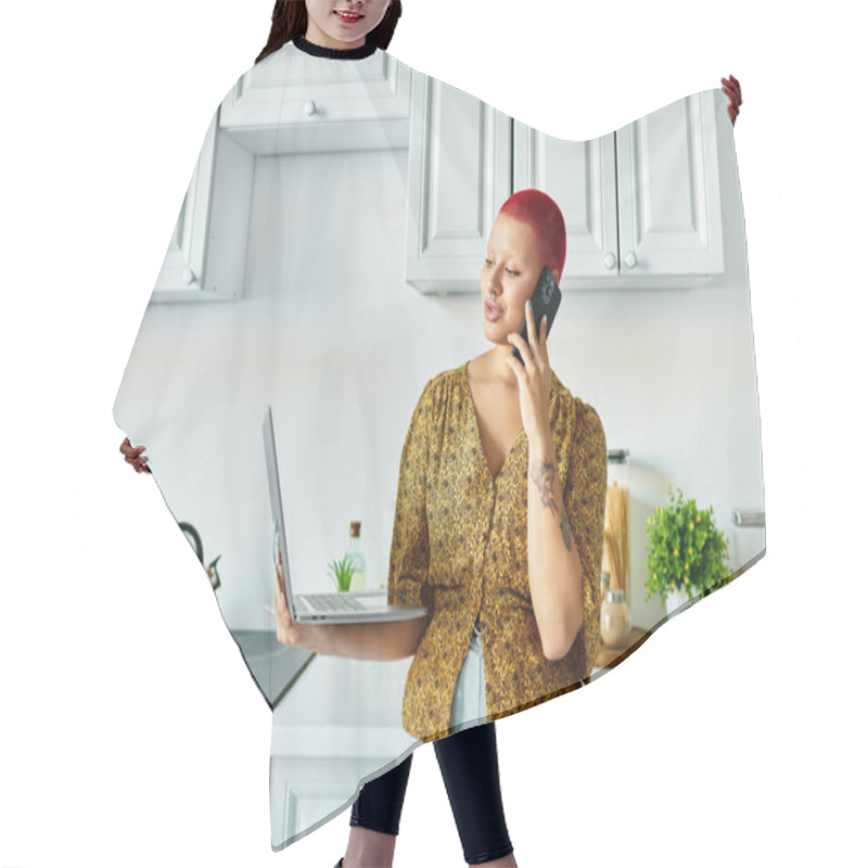 Personality  A Bold Bald Woman Engages In A Call, Seamlessly Balancing Her Laptop In A Modern Kitchen Setting. Hair Cutting Cape