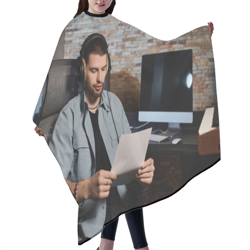 Personality  A Man Absorbed In Reading A Sheet Of Paper While Sitting In A Chair During A Music Band Rehearsal In A Recording Studio. Hair Cutting Cape