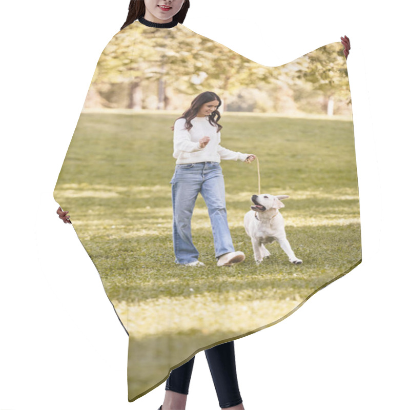 Personality  A Young Woman In Cozy Autumn Attire Walks Happily With Her Dog In A Sunlit Park. Hair Cutting Cape